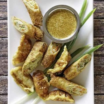 homemade Benihana magic mustard sauce and egg rolls on a platter