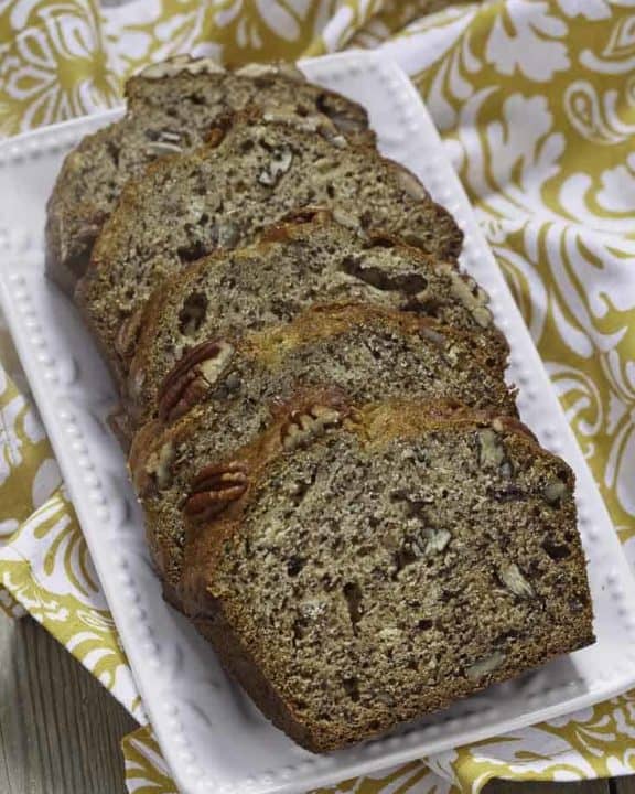4 slices of banana bread with pecans on a plate