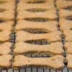 dog bone shaped dog biscuits on a baking rack