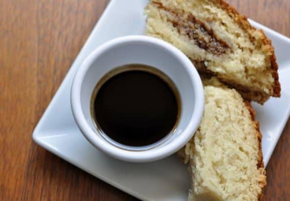 Guinness dipping sauce and 2 slices of Irish soda bread on a plate