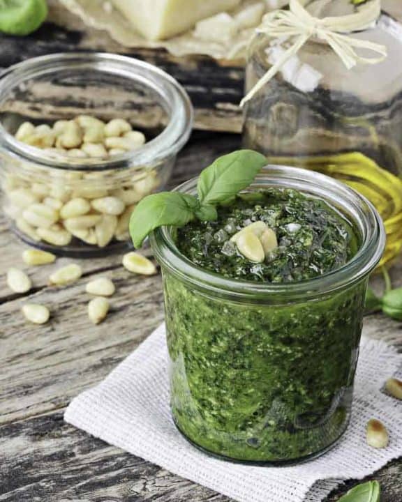 a jar of homemade pesto with pine nuts