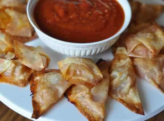 pizza won tons and sauce on a plate