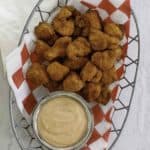 a basket filled with chicken nuggets and dipping sauce