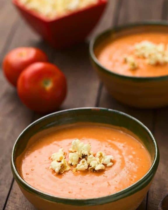 two bowls of creamy tomato soup