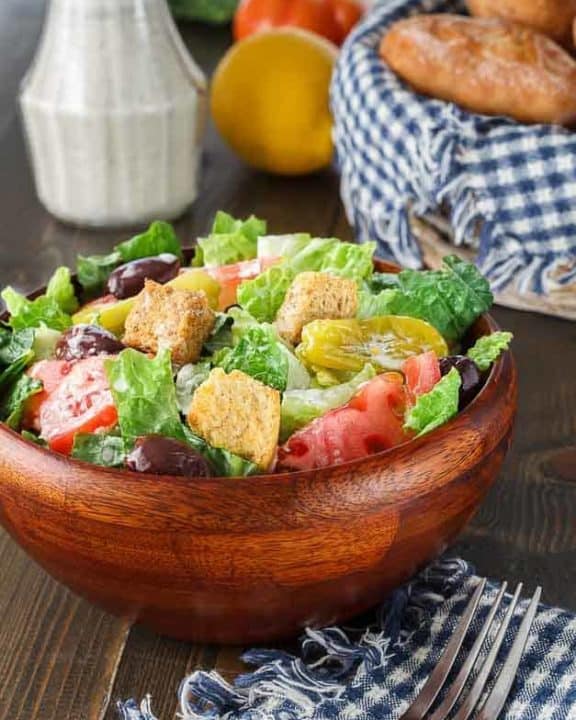 Homemade copycat Olive Garden Salad Dressing and a salad.
