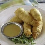 Copycat Chili's Chicken Crispers and honey mustard sauce on a white plate.
