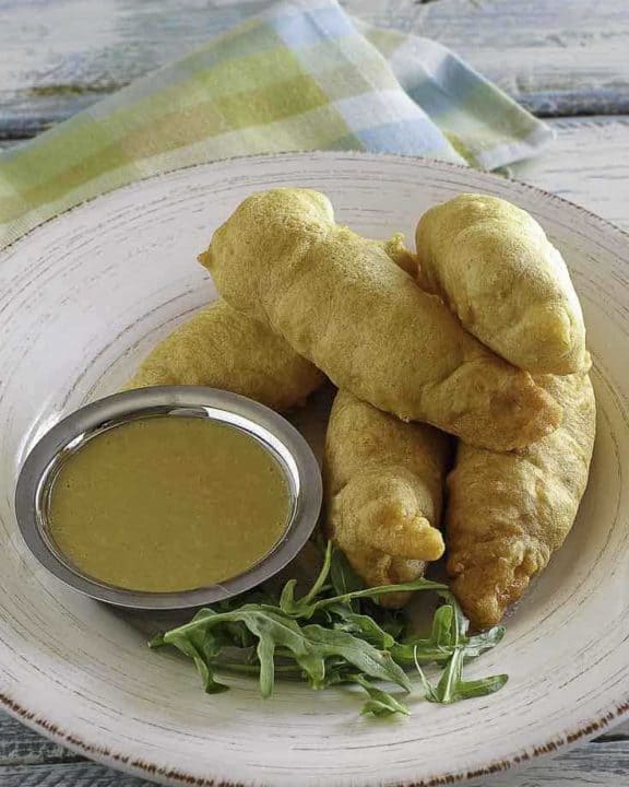 Copycat Chili's Chicken Crispers and honey mustard sauce on a white plate.