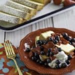 Homemade copycat Sara Lee Pound Cake with fruit in front of the cake on a platter.
