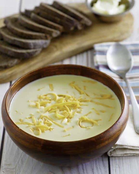 Homemade copycat Outback Walkabout Soup in a bowl in front of sliced wheat bread.