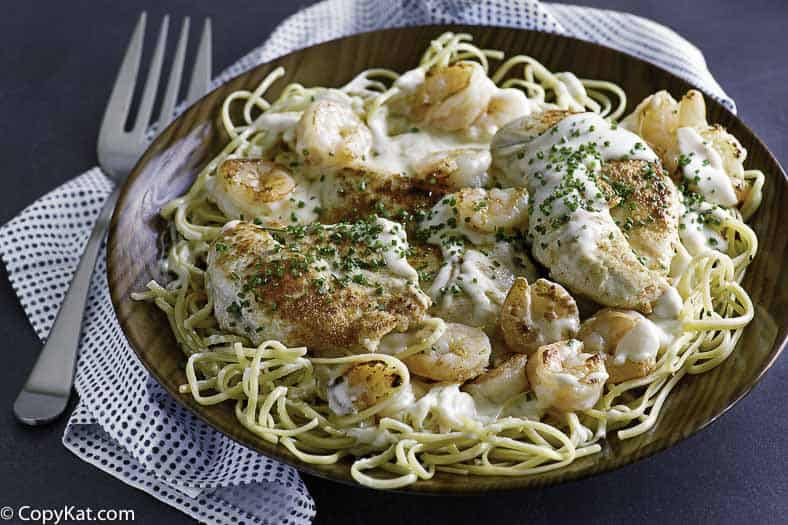 Homemade copycat Outback Steakhouse Queensland Chicken and Shrimp in a brown wood bowl.