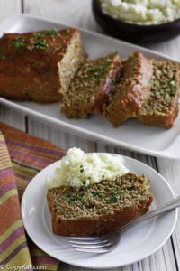 Homemade Boston Market Meatloaf on a plate and serving dish.
