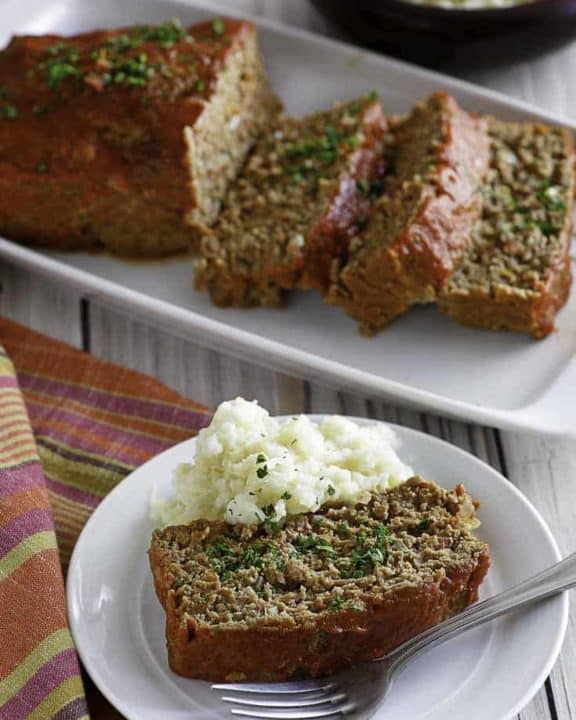 Homemade Boston Market Meatloaf on a plate and serving dish.