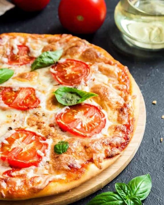 Margherita pizza on a pizza stone.
