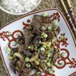 A plate of Mongolian beef and a bowl of rice