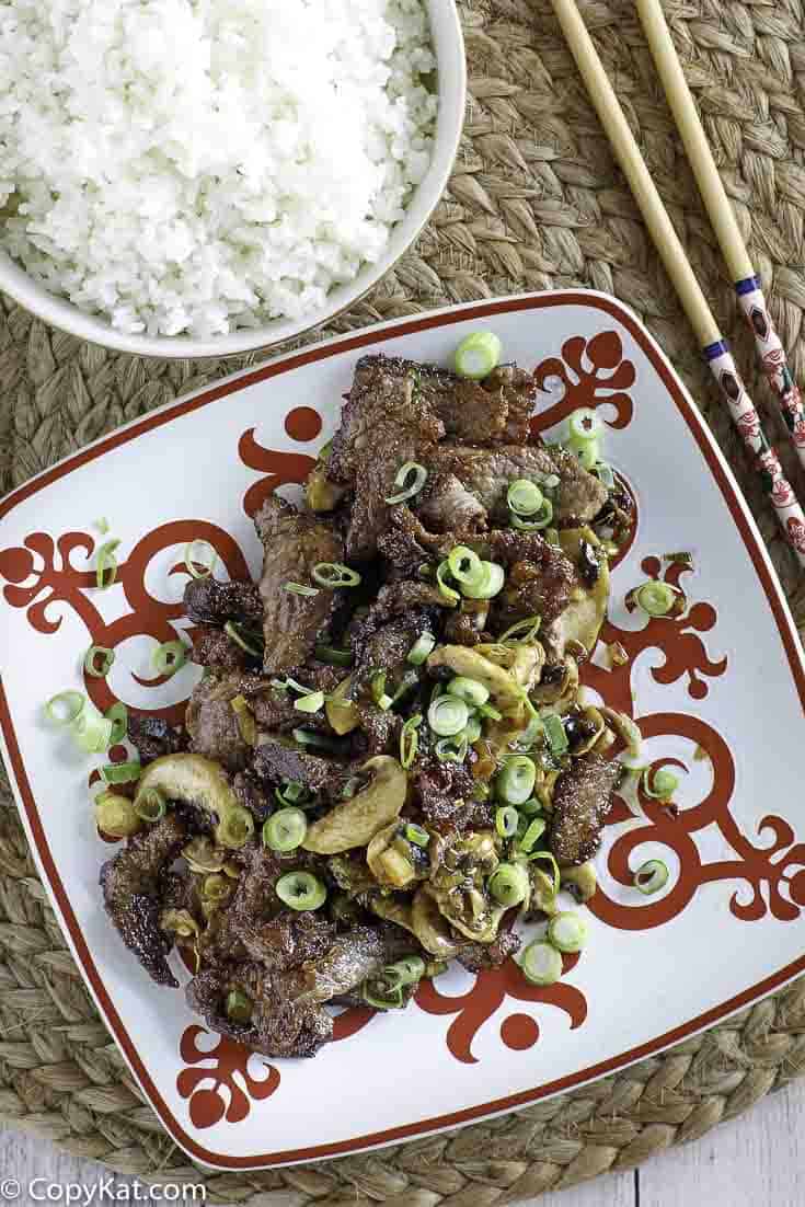 A plate of Mongolian beef and a bowl of rice