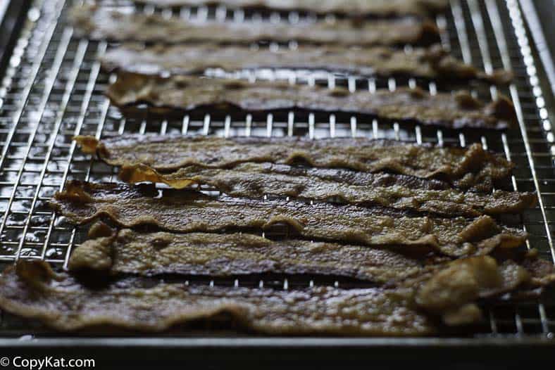 Cooked bacon on a baking sheet.