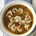 Shrimp cooked in a spicy broth in a bowl.