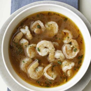 Shrimp cooked in a spicy broth in a bowl.
