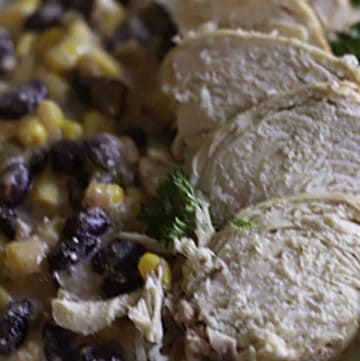 A plate of black beans, corn, and chicken that were prepared in a slow cooker.