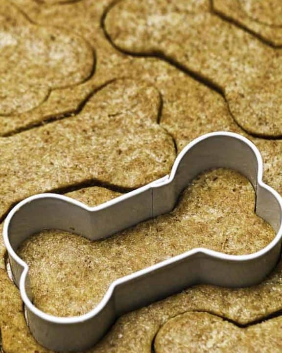 Cutting out dog biscuits with a bone shaped cutter.