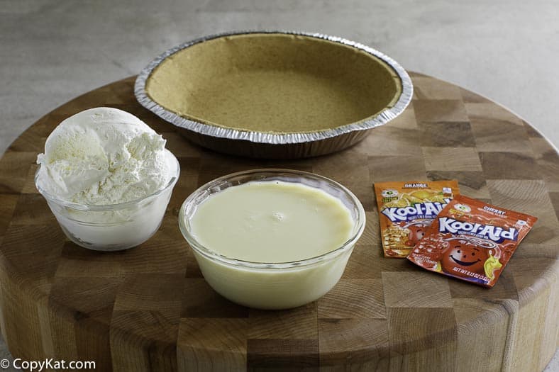 Ingredients for kool aid pie, Cool Whip, Kool Aid, Sweetened Condensed Milk, and a pie shell