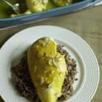A plate with a chicken breast made with a sauce of lemon Jello and more.