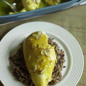 A plate with a chicken breast made with a sauce of lemon Jello and more.