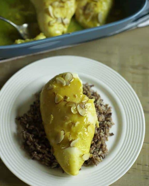 A plate with a chicken breast made with a sauce of lemon Jello and more.