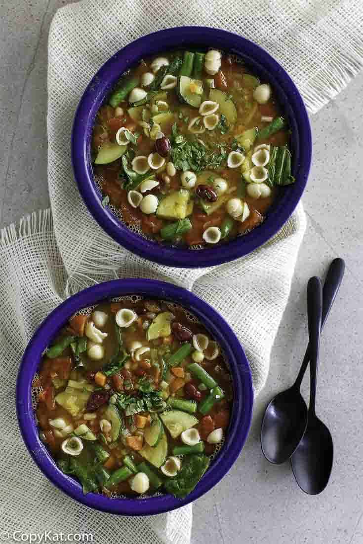 Overhead view of copycat Olive Garden minestrone soup in two bowls.