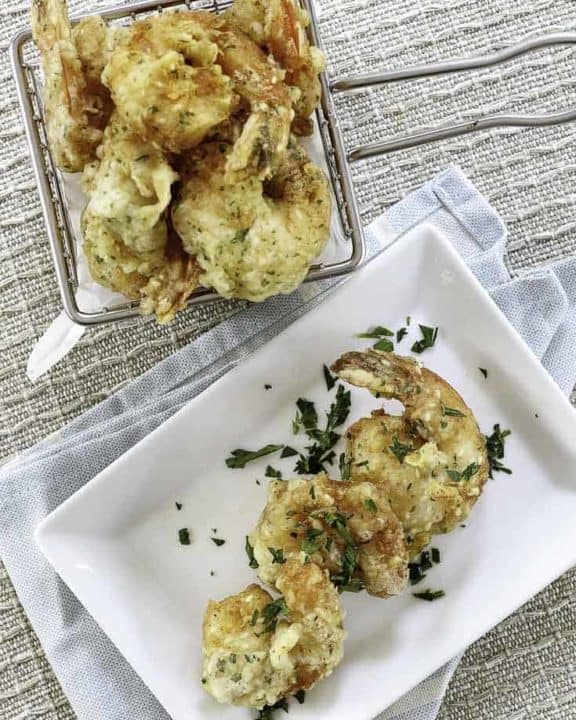 A basket and a plate of homemade shrimp tempura