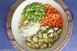 A stockpot full of celery, onions, carrots, and Zucchini