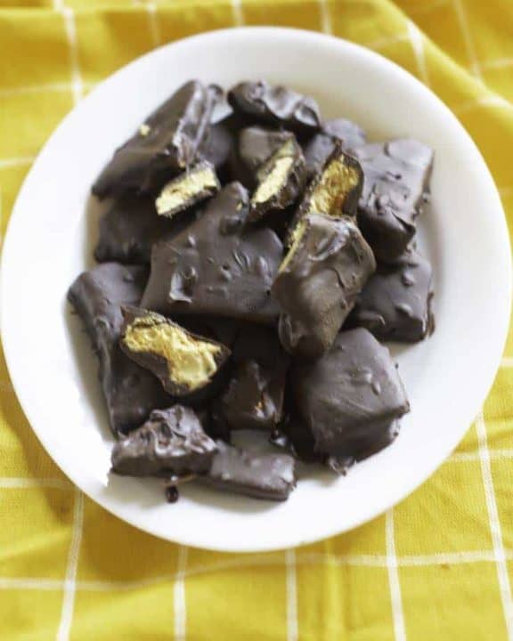 chocolate dipped fools gold candy on a white plate