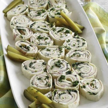 ham and cheese tortilla pinwheel roll ups on a platter