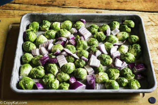 placing cut Brussel Sprouts on the sheet pan before baking them