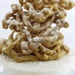 Homemade funnel cakes dusted with powder sugar.
