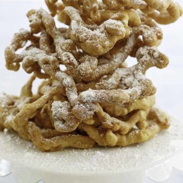 Homemade funnel cakes dusted with powder sugar.