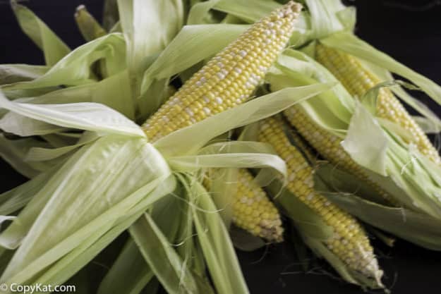 Partially husked corn, just the silks are removed 