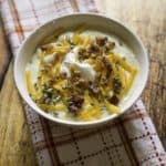 baked potato soup with cheese, sour cream, and scallions