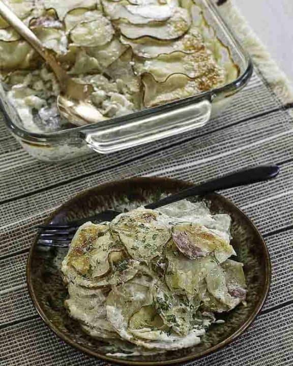 a plate of cheesy scalloped potatoes and ham