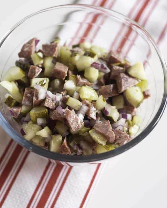 salami salad made with salami, onions, pickles, and olive oil
