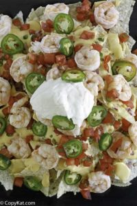 Cheesy nachos with shrimp, cheese, sour cream and more