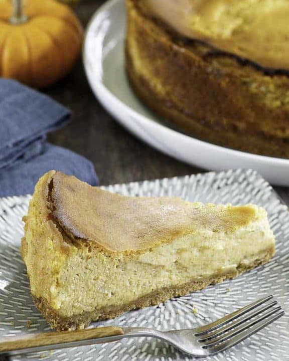 a slice if pumpkin cheesecake on a plate