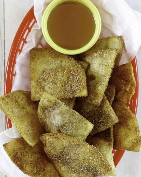 a basket of cinnamon sugar tortilla chips and honey