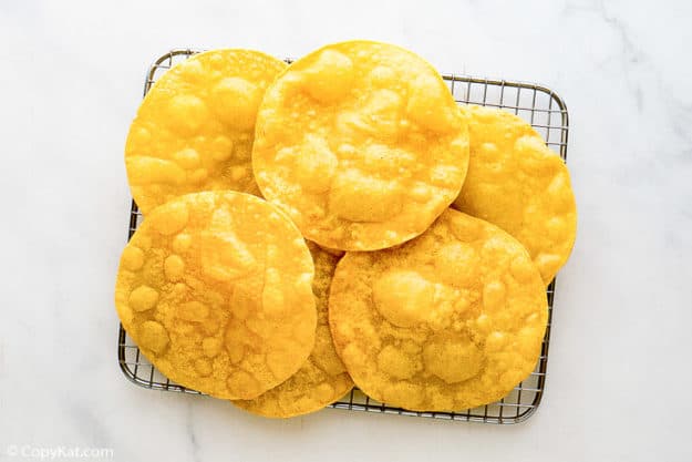 Fried corn tortillas on a rack