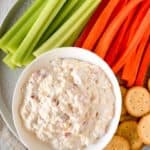old fashioned pimento cheese spread on a platter with celery, carrots, and crackers