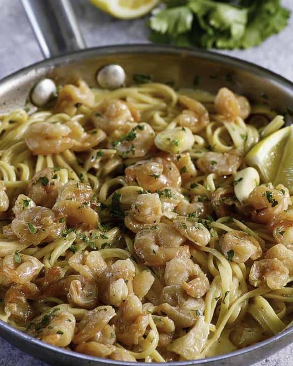 a skillet of garlic shrimp pasta