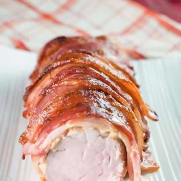 brown sugar bacon wrapped pork tenderloin on a platter