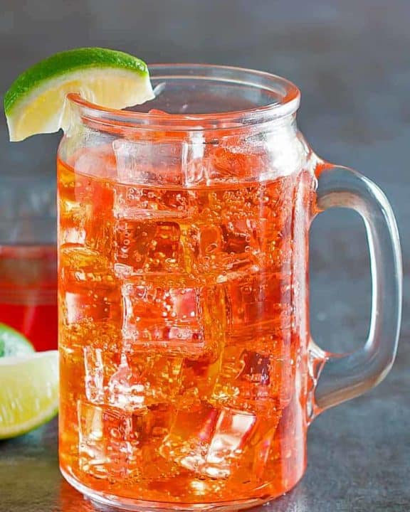cherry limeade in a glass with a handle