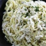 A plate of alfredo pasta with crab