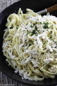 A plate of alfredo pasta with crab